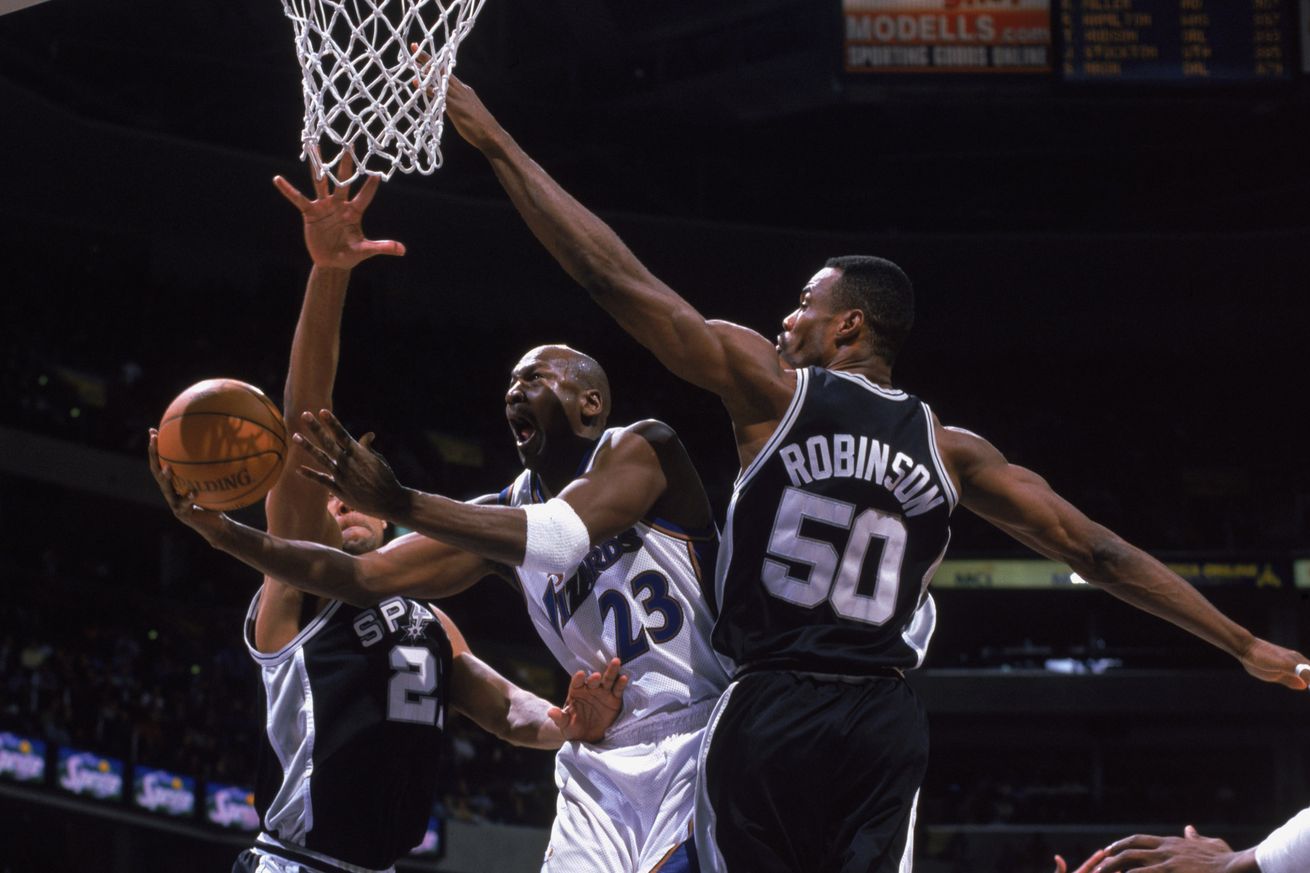 Michael Jordan shoots between David Robinson and Tim Duncan