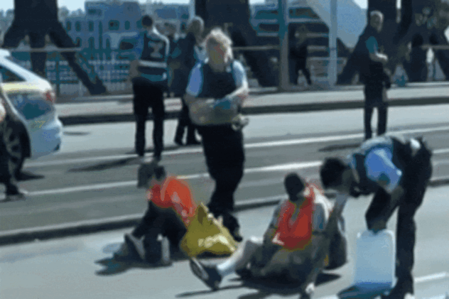Cop accused of dumping oil on climate protester blocking road