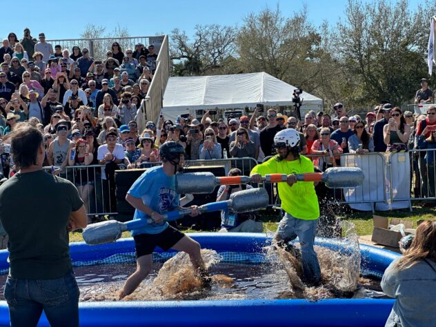 At the Florida Man Games, tank-topped teams compete at evading police, wrestling over beer