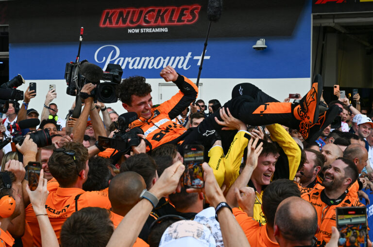 Lando Norris celebrates first Formula 1 win with insane dive into crew, champagne spike