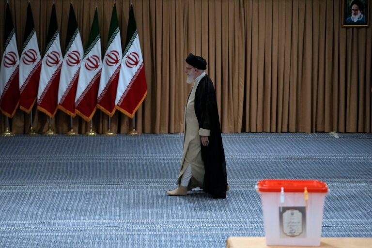 Iran holds runoff presidential vote pitting hard-liner against reformist after record low turnout