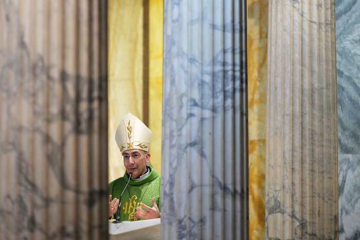 Pope Francis sits upright in an armchair as Argentines in Rome pray for his recovery
