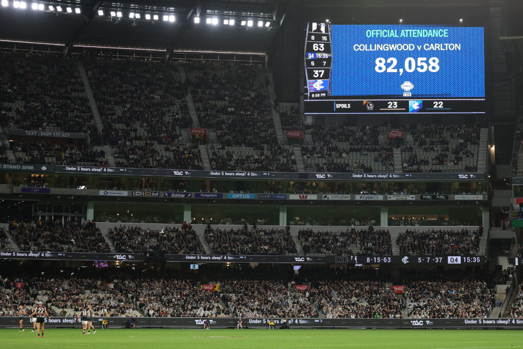 Two men allegedly brought guns into Australian Football League match with 82,000 in attendance