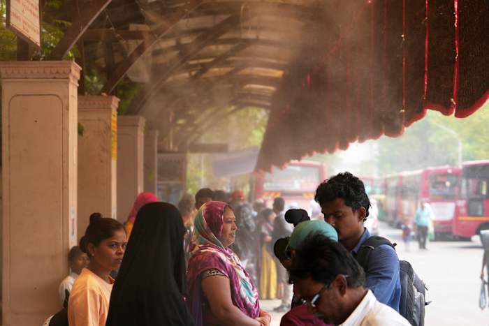 In one Indian city, reflective paint and bus stop sprinklers offer relief from killer heat