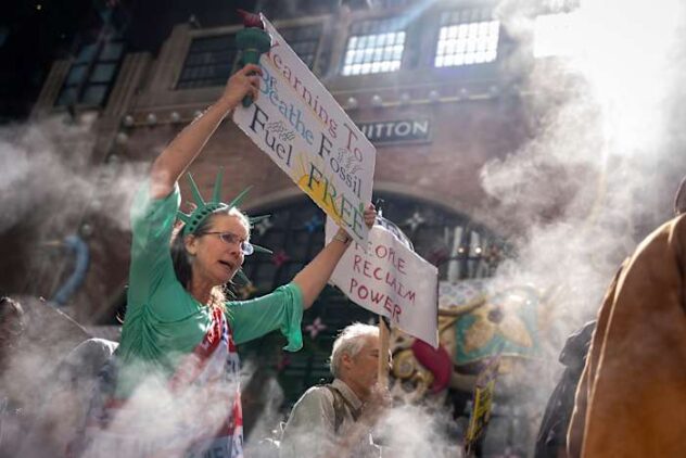 Marchers gather in worldwide protest of financial institutions 'profiting off the climate crisis'