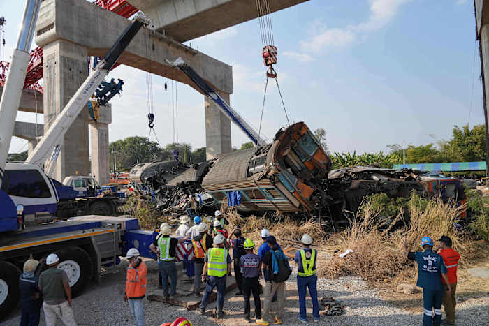 A construction crane falls onto a moving train in Thailand, killing at least 29 people