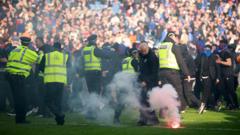 Police separate Celtic and Rangers fans after Ibrox pitch invasion