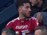 Rayan Cherki is told to REMOVE Liverpool shirt after annoying Man City coaching staff by wearing it on the bench after swapping with fellow substitute Hugo Ekitike in bizarre incident - as fans slam Reds striker