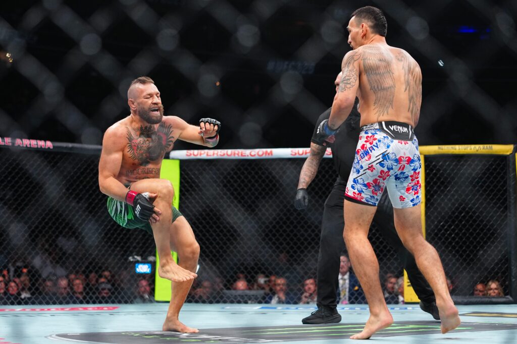Conor McGregor injures leg seconds into fight in loss to Max Holloway — and is heavily booed by UFC 329 fans