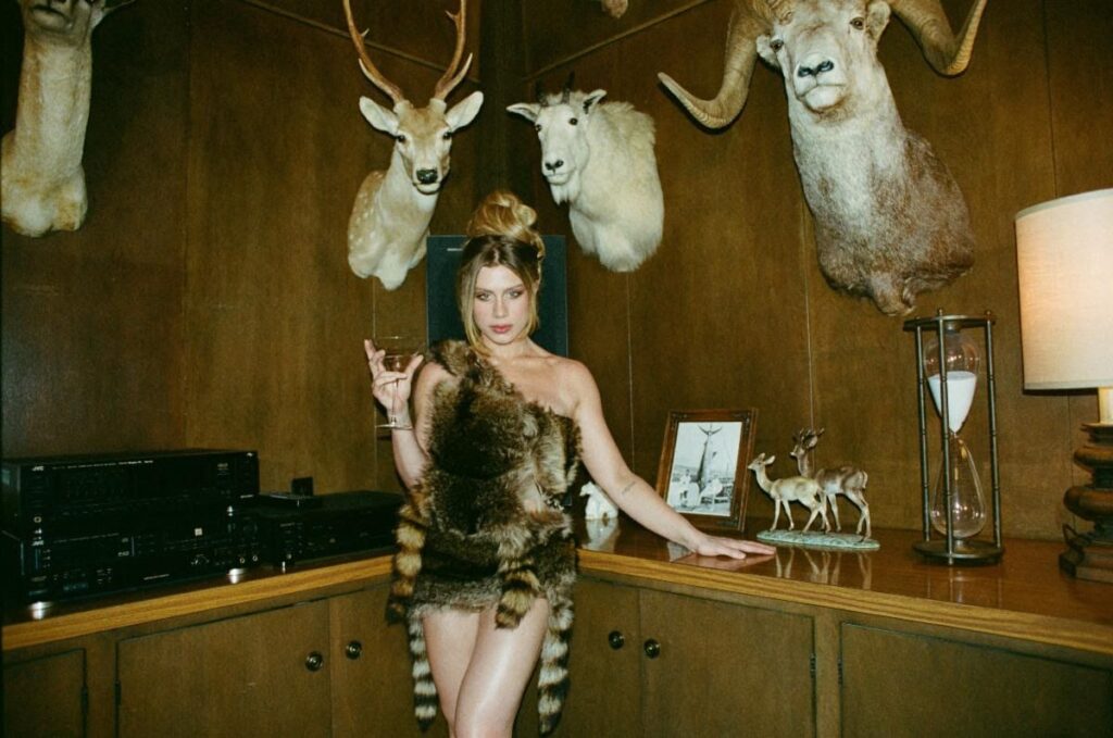 Watch Slayyyter Rock a Raccoon Pelt in “I Think He’s Got a Girl” Video